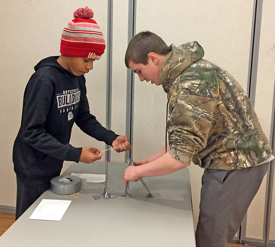 Boyceville Middle School students Caden Wold, at left, and Parker Coombs found duct tape helpful as they stabilized their drinking straw catapult.