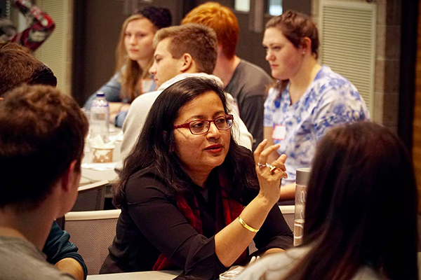 Professor Lopa Basu, co-chair of the Literature Committee, works with students.