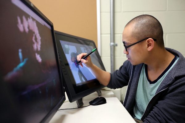 Hue Vang, who created Sun of the Children, works in a UW-Stout game design lab.