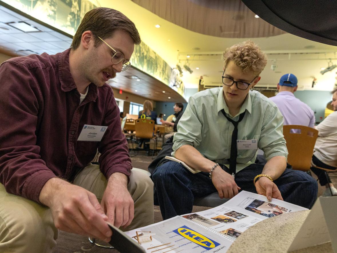 Two people look at a document