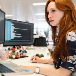 A woman looking a a computer screen