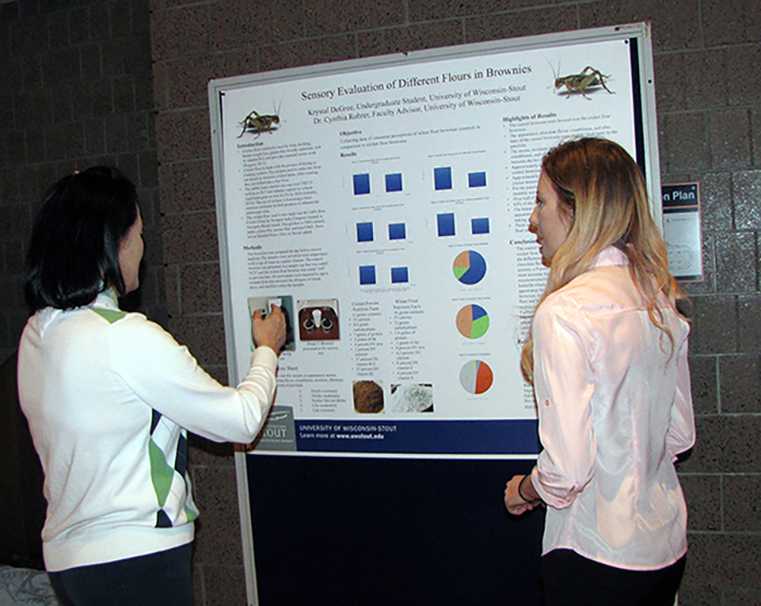 Krystal Degree, right, and Eun Joo Lee, food and nutrition department chair, discuss DeGree’s research on flour made from crickets.