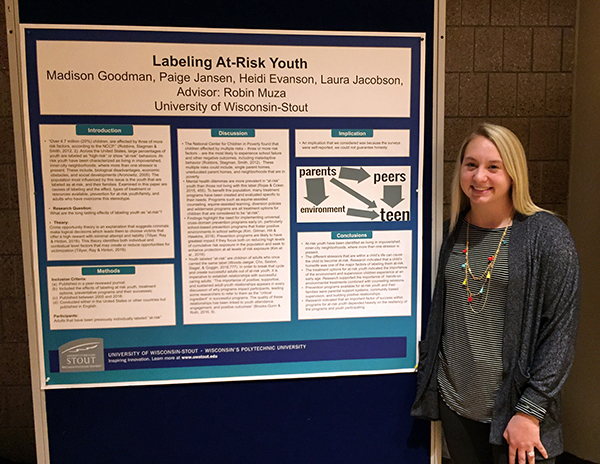 Heidi Evanson, who graduated Dec. 15, with a degree in human development and family studies, presents research on at-risk youth.
