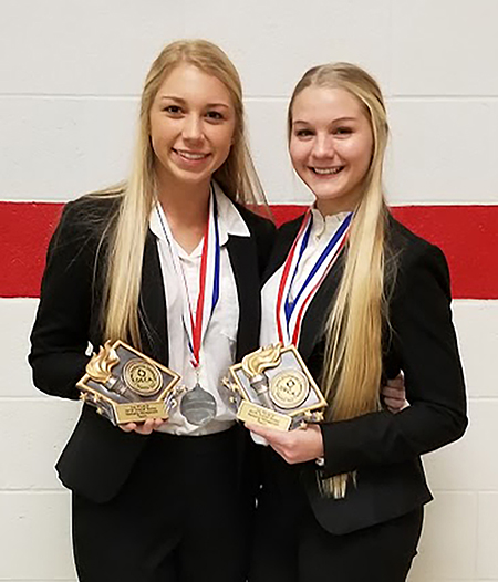 Katelyn Steinmetz, left, and Rachel Spaeth of Chippewa Falls took first place in the marketing management team competition in the DECA event.