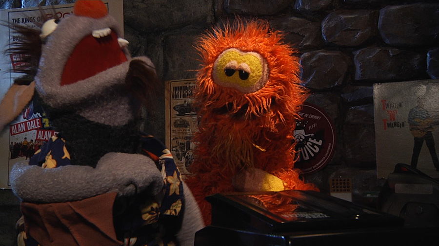 Furry Ackermonster, an orange yeti, is the station manager at Transylvanian Television.”