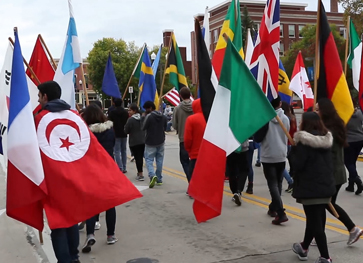 Photo of International Students in parade with flags
