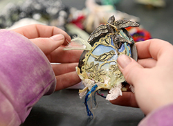UW-Stout student Mindy Allee works on a brooch.