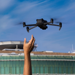 A hand reaching for a drone