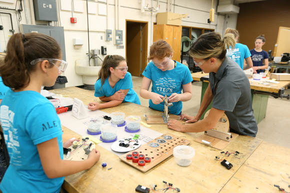Kari Berthiaume helps STEPS for Girls participants with their robot projects in an engineering lab at UW-Stout.