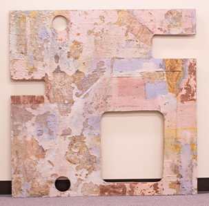 Abstract mixed-media installation with ceramic forms, tubing, and painted panels on a metal frame, on display at the Furlong Gallery.