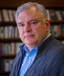John Fea sitting in front of a bookshelf