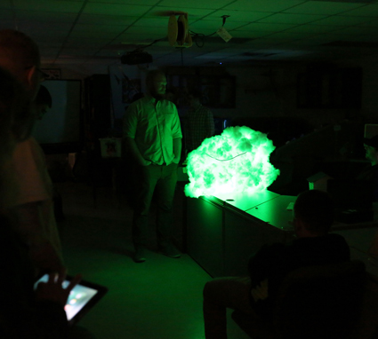Student William Hibbard explains his project, a “cloud” wired and programmed to change colors.
