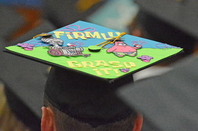 Graduate Brendon Schumacher’s mortarboard Dec. 16 included the SpongeBob SquarePants characters Squidward Tentacles, left, and Patrick.