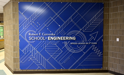 The main entrance to Fryklund Hall at UW-Stout features a new sign for the Robert F. Cervenka School of Engineering.