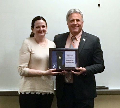 Becky Simonson receives the award from Chancellor Bob Meyer.