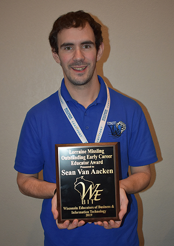 Sean Van Aacken with his Outstanding Early Career Educator Award.