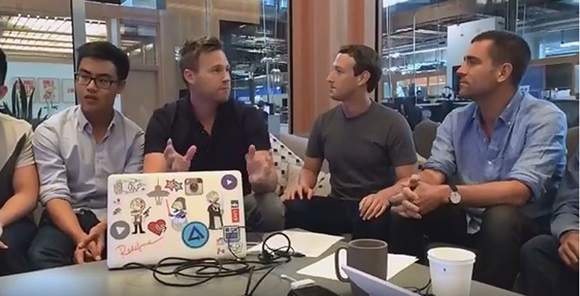 Brady Voss, center, talks with Facebook founder and CEO Mark Zuckerberg, second from right, during a hackathon event at Facebook headquarters.
