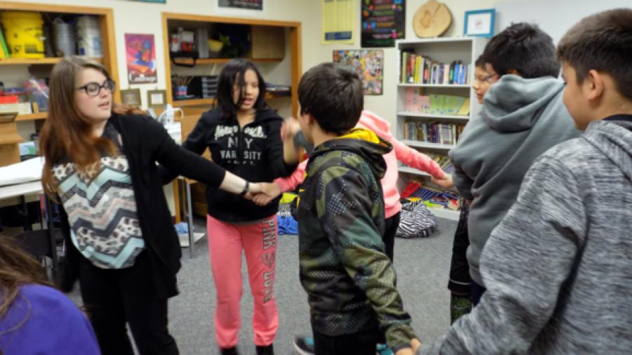 UW-Stout student Skylar Kitchner leads a career and education development activity with LCO sixth-graders.
