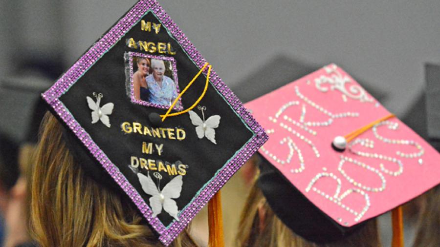 The mortarboard of UW-Stout graduate Kelsey Srdar’s includes a photo herself with her grandmother, Mickey, who died July 4. At right is the cap of "Girl Boss" Samantha Sova, who will be an assistant manager at Kohl's.