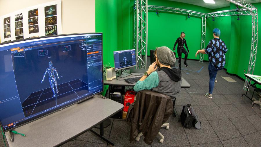 Andrew Fedie, left, watches the movements of fellow student Danielle Pedersen as she is directed by Kayla Techmeier in UW-Stout’s new motion capture studio in Micheels Hall.