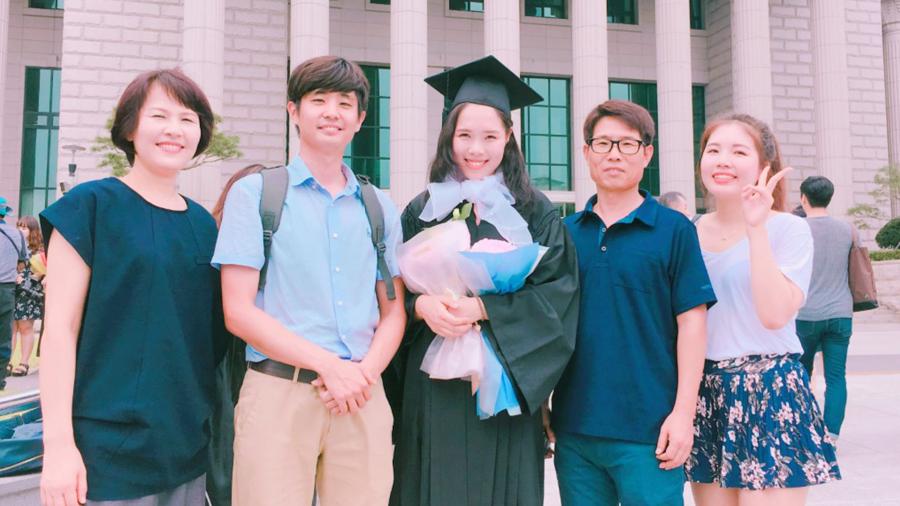 Jeongwon Kim, center, with her family at her graduation from Hankuk University of Foreign Studies.