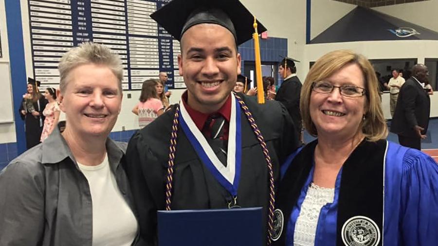 Jones celebrates his graduation from UW-Stout with former staff member Julie Miller, left, and Linda Young, transfer coordinator.