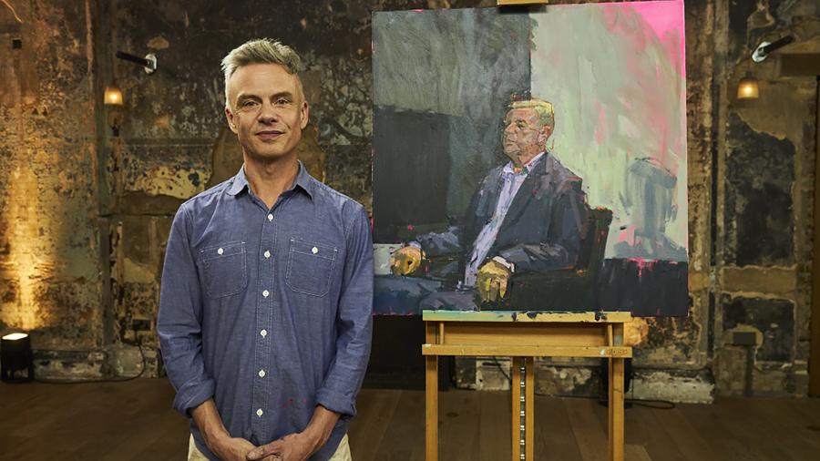 Tozer poses on the set of Portrait Artist of the Year with his painting of musician Suggs that won an opening round of the televised competition.