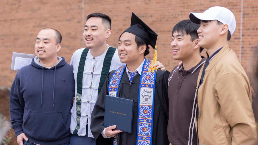 A graduate celebrates with his supporters.