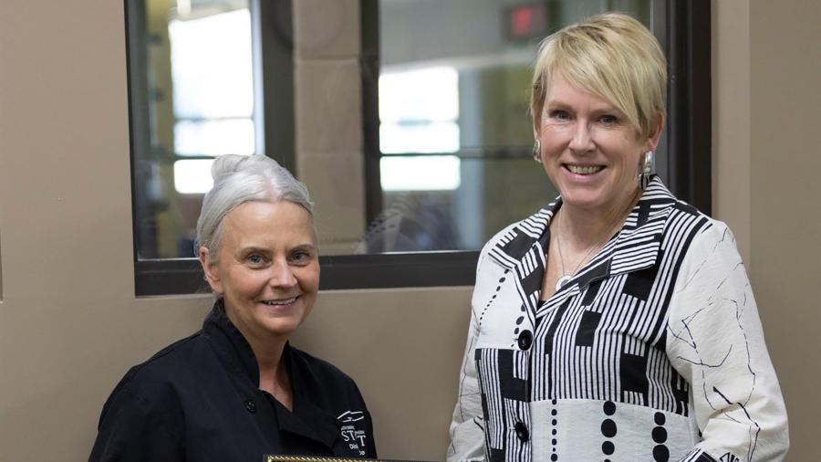 Donna Zerbian, left, receives the May University Staff Employee Appreciation award from Chancellor Katherine Frank.