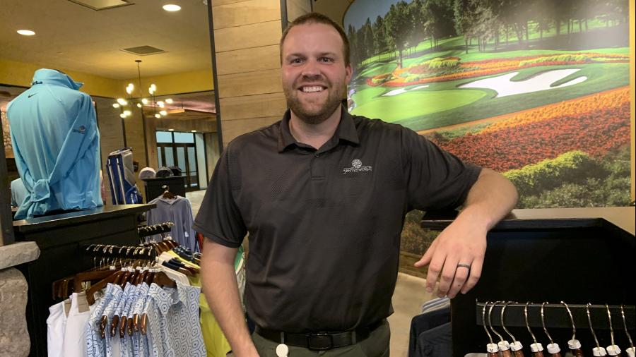 Saari works from the SentryWorld pro shop, which features a mural of the course’s Flower Hole, in the background.