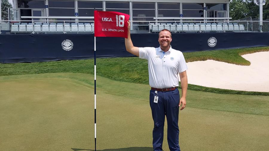 Assistant PGA Pro Aaron Saari, a 2018 UW-Stout golf enterprise management alum, stands on the 18th green at SentryWorld.