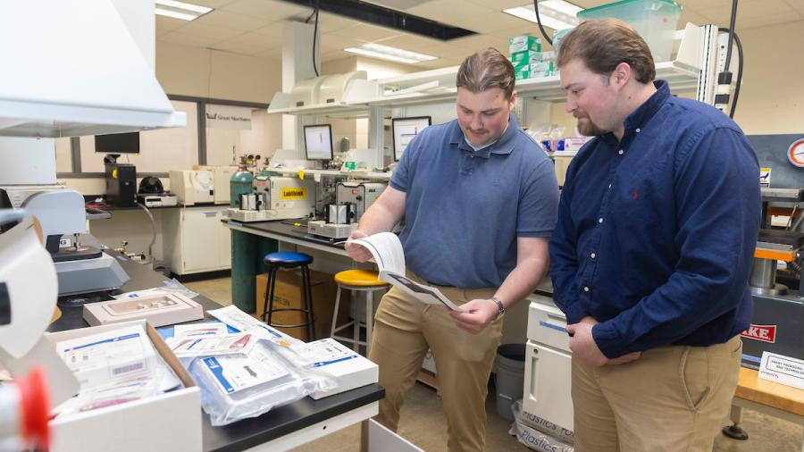 Adam, left, and Jack Brisson in a packaging lab.