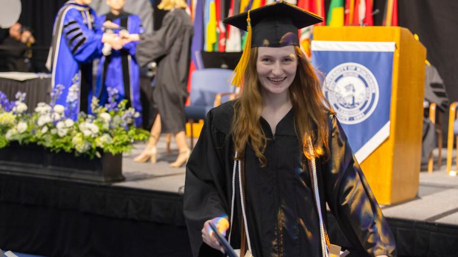 A student celebrates at commencement.