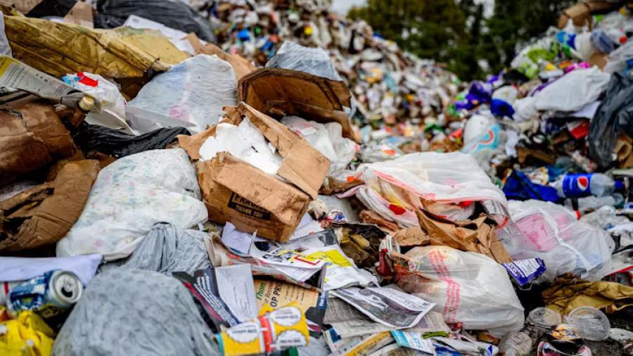 A mound of items sent for recycling includes a lot of plastic bags.