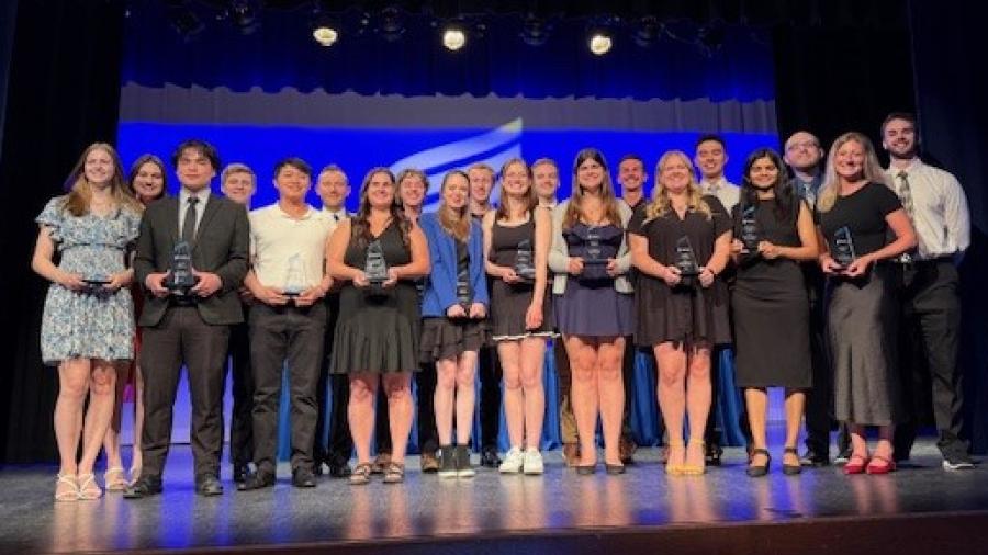 A group of students pose with their co-op award plaques