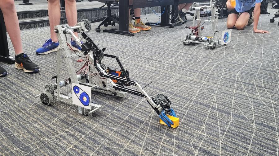 A student-designed robot picks up a plastic block