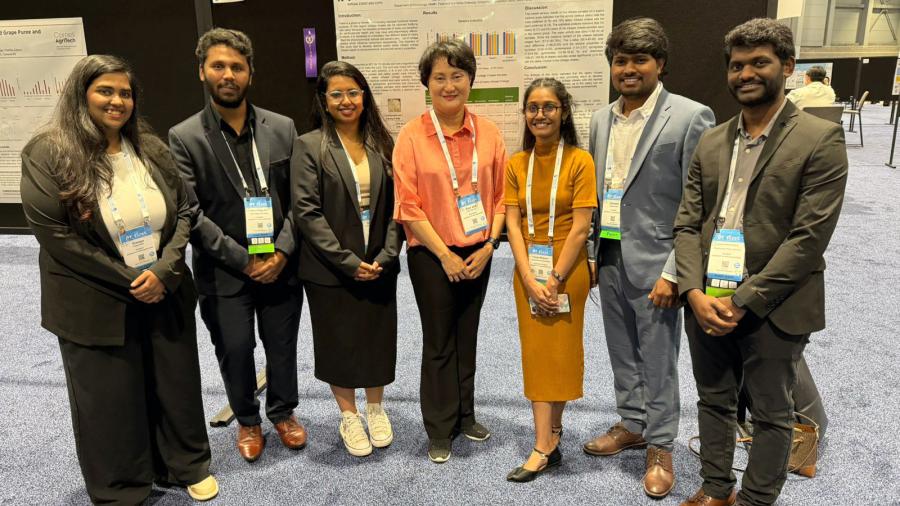 Seven people post at a conference