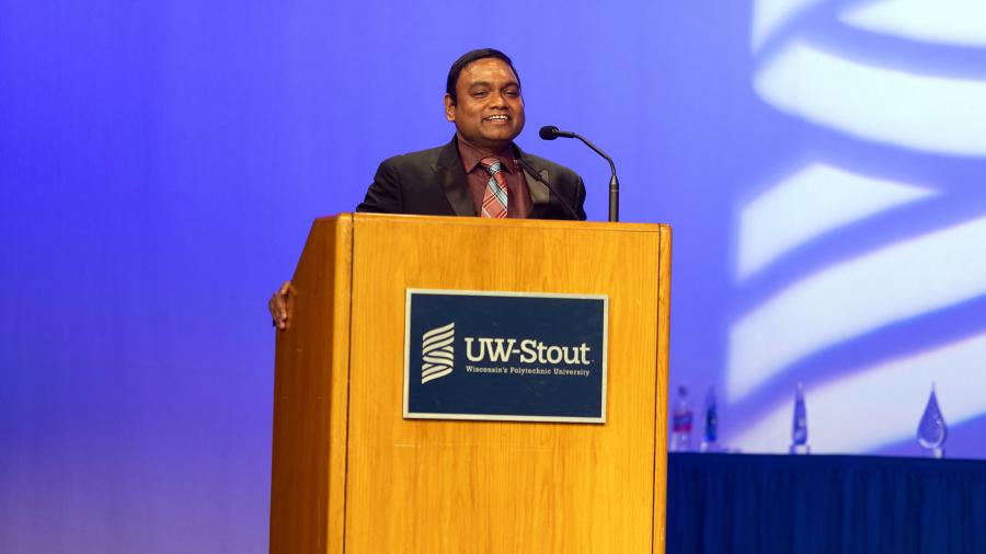 A man speaks at a podium