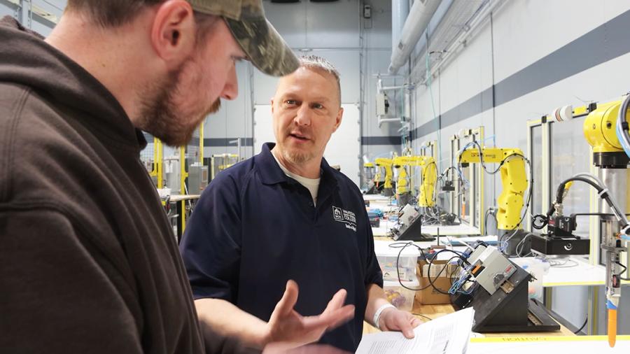 Jason Solberg and a student in an automation lab