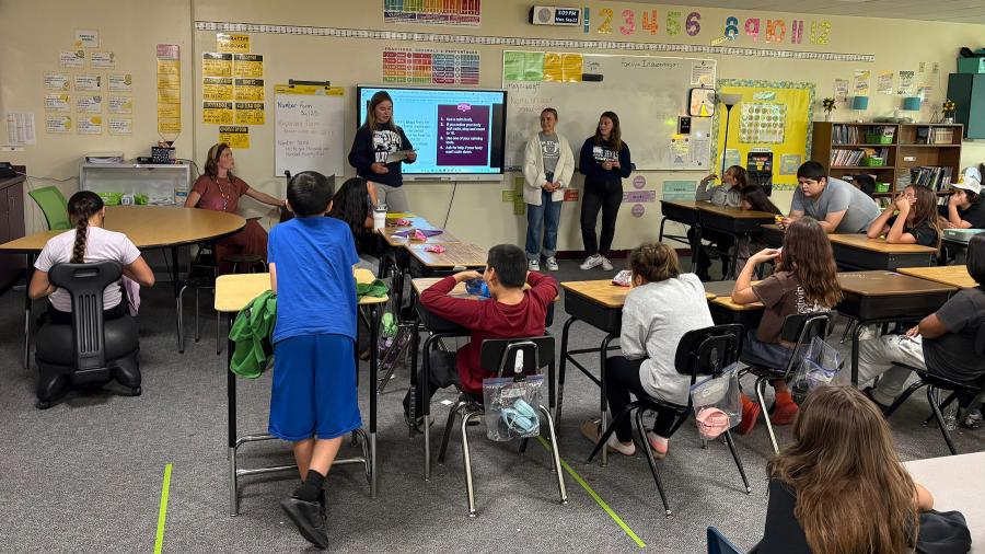 School psychology students talk with an elementary classroom