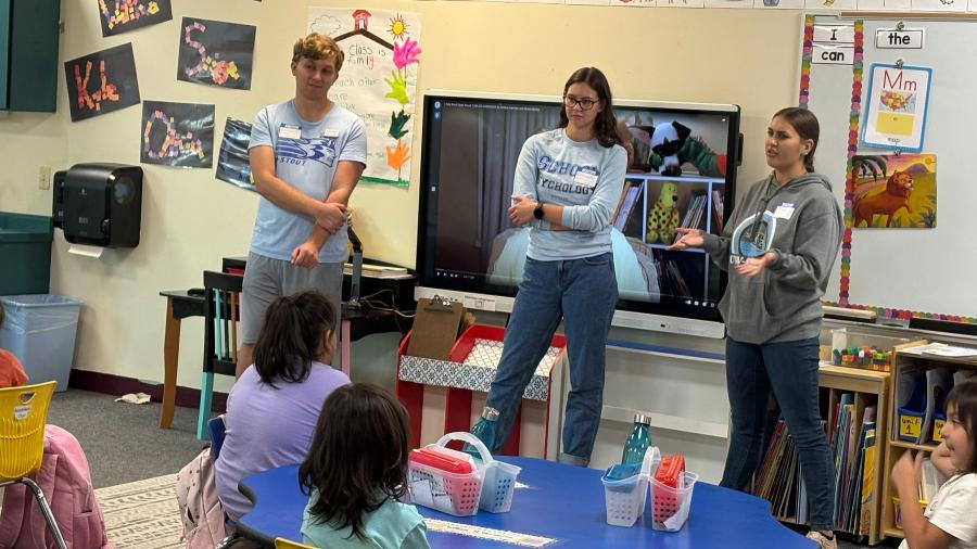 School psychology students talk with an elementary classroom