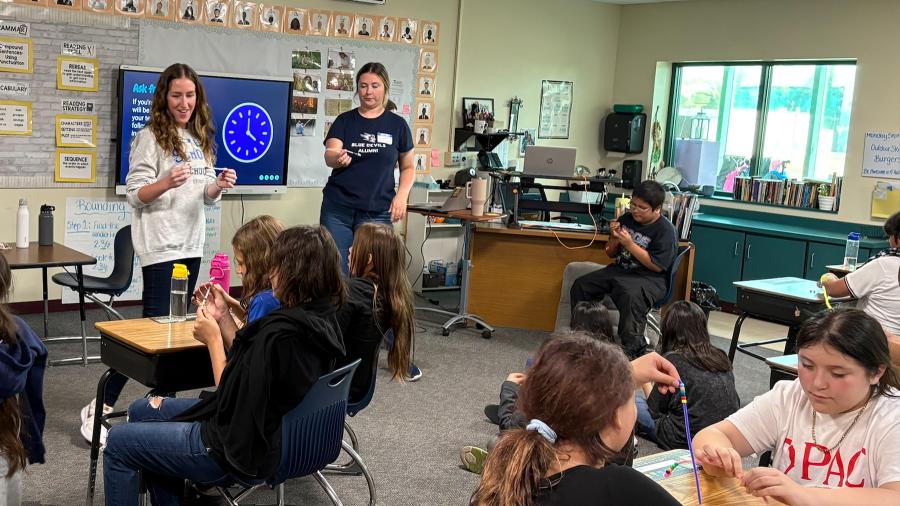School psychology students talk with an elementary classroom