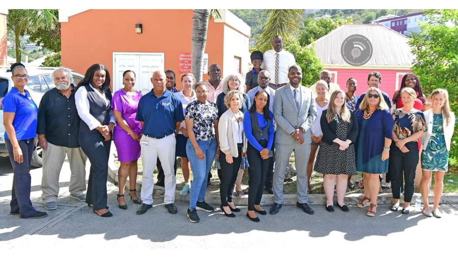 Natasha Harrigan, center in blue, standing next to the premier of the British Virgin Islands after contributing to a stakeholder meeting
