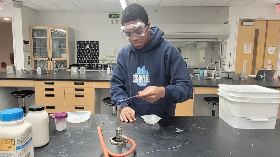 Honors chemistry student conducting an experiment on sugar combustion