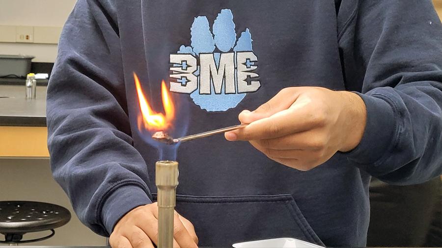 Honors chemistry student conducting an experiment on sugar combustion