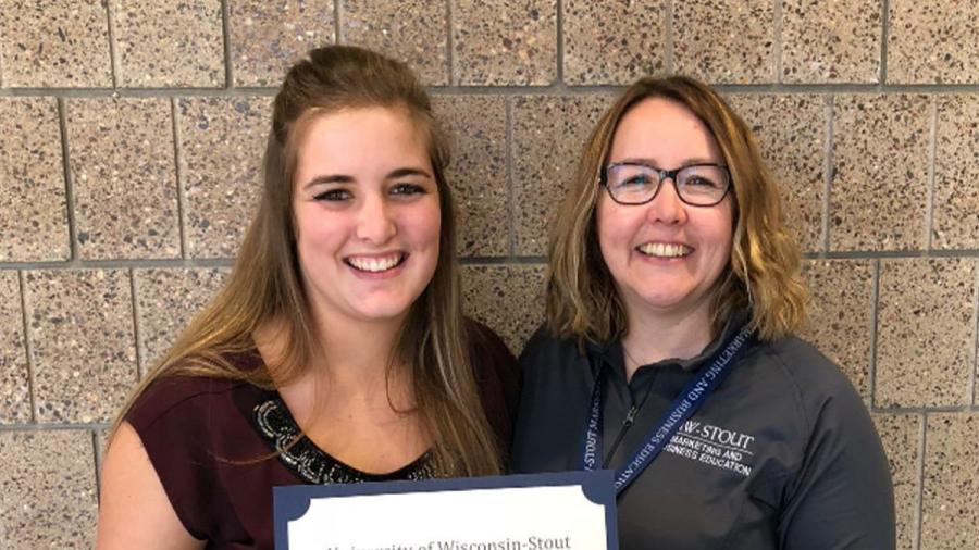 Two women holding certificate