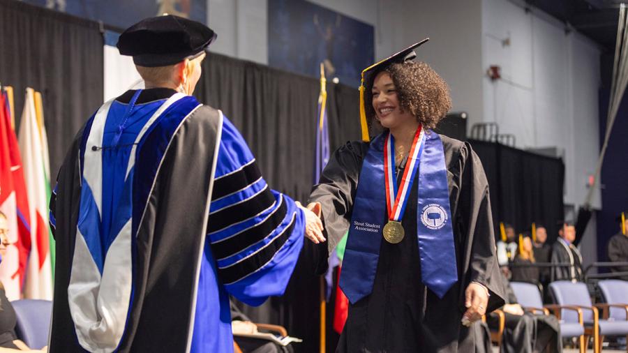 Woman receives college diploma