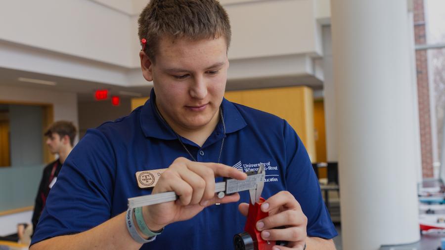 A university student judges a challenge during the SkillsUSA Regional Competition