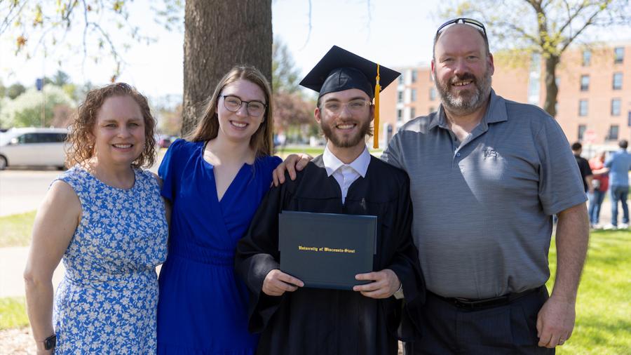 A family celebrates with their graduate at commencement