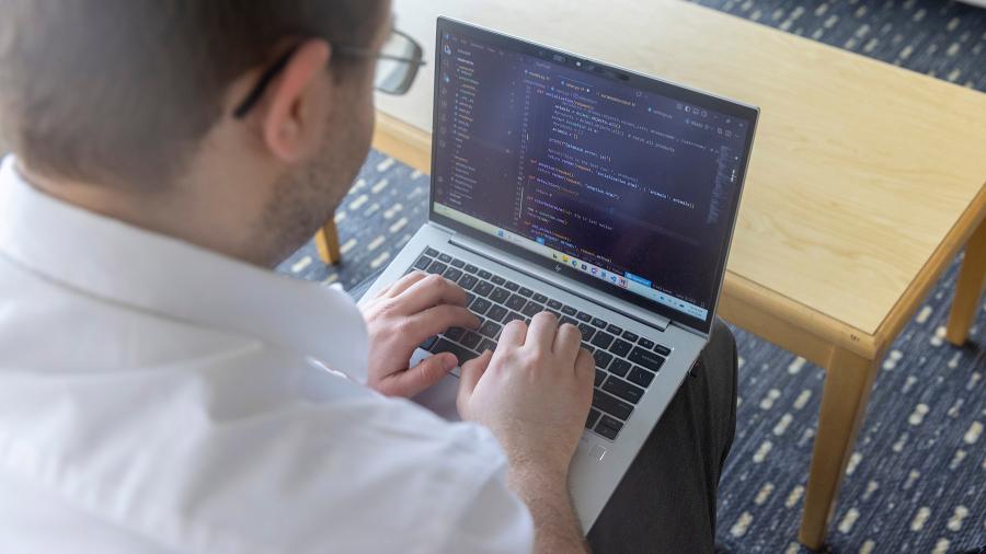 Man typing on laptop